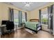 Bright bedroom with natural light, ceiling fan, hardwood floors, a desk, and neutral walls at 1614 Cottage Cove Circle, North Myrtle Beach, SC 29582