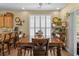 This dining room features a wooden table, chairs, and decor next to a window with white shutters at 1614 Cottage Cove Circle, North Myrtle Beach, SC 29582