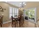Cozy dining area featuring a wood table, modern chandelier, and sliding door to deck at 1614 Cottage Cove Circle, North Myrtle Beach, SC 29582