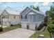 Charming coastal-style home featuring a raised foundation and double garages, with meticulous landscaping at 1614 Cottage Cove Circle, North Myrtle Beach, SC 29582