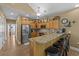 This kitchen features wooden cabinets, stainless steel appliances, and a breakfast bar with granite countertops at 1614 Cottage Cove Circle, North Myrtle Beach, SC 29582