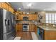 Well-equipped kitchen featuring stainless steel appliances, oak cabinets, and granite countertops at 1614 Cottage Cove Circle, North Myrtle Beach, SC 29582