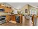 Bright kitchen with stainless steel appliances, oak cabinetry, and seamless access to living area at 1614 Cottage Cove Circle, North Myrtle Beach, SC 29582