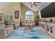 Bright living room with vaulted ceiling, arched window, and cozy seating arrangement at 1614 Cottage Cove Circle, North Myrtle Beach, SC 29582