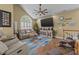 Inviting living room featuring a vaulted ceiling, cozy seating, and a vibrant area rug at 1614 Cottage Cove Circle, North Myrtle Beach, SC 29582