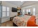Vaulted ceiling bedroom boasts a large bed, wood floors, windows with shutters, and a large TV at 1614 Cottage Cove Circle, North Myrtle Beach, SC 29582