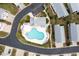 Aerial view of the community pool with blue lounge chairs and nearby houses at 1614 Cottage Cove Circle, North Myrtle Beach, SC 29582