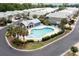 Aerial view of the community pool with lounge chairs and a nearby covered cabana at 1614 Cottage Cove Circle, North Myrtle Beach, SC 29582