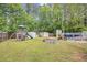 Backyard with pool, playset, storage sheds, fire pit, and lush green grass at 1894 Athens Dr., Conway, SC 29526