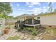 Landscaped backyard with a covered patio, garden area, stone walkway, and lush greenery at 1894 Athens Dr., Conway, SC 29526