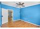 Blue bedroom with wood floors, a window, and a doorway leading to another room at 1894 Athens Dr., Conway, SC 29526