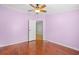 Bright bedroom with a ceiling fan, wood floors, and a doorway leading to another room at 1894 Athens Dr., Conway, SC 29526