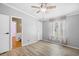 Bright bedroom with light wood floors, ceiling fan, and a large window at 1894 Athens Dr., Conway, SC 29526