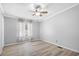 Neutral bedroom with light wood floors, ceiling fan, and a window with sheer curtains at 1894 Athens Dr., Conway, SC 29526