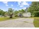 Well-maintained single-story home featuring a long driveway, lush landscaping, and mature trees at 1894 Athens Dr., Conway, SC 29526
