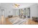 Bright living room offers neutral paint, wood-look flooring, and an open concept layout at 1894 Athens Dr., Conway, SC 29526