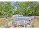 An above-ground pool with a white fence and a slide in a tree-filled backyard setting at 1894 Athens Dr., Conway, SC 29526