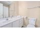 Neutral-toned bathroom featuring a white vanity, toilet, and a shower behind a curtain at 2101 Firebird Ln. # 14, Myrtle Beach, SC 29577