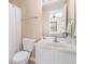 Bright bathroom with a white vanity, toilet, and shower with a curtain, offering a clean and functional space at 2101 Firebird Ln. # 14, Myrtle Beach, SC 29577