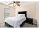 Cozy bedroom with a ceiling fan, carpet, and a comfortable-looking queen bed with matching nightstand at 2101 Firebird Ln. # 14, Myrtle Beach, SC 29577