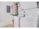Functional laundry room with washer, dryer, water heater, and storage shelves, maximizing space and convenience at 2101 Firebird Ln. # 14, Myrtle Beach, SC 29577