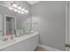 Bathroom featuring a double vanity, mirror, a pink rug and neutral colored walls at 212 Greenwich Dr., Conway, SC 29526