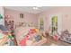 Bright bedroom with plush decor, wood-look floors, ceiling fan, and an abundance of natural light at 212 Greenwich Dr., Conway, SC 29526