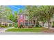 Inviting two-story home featuring a double porch, red siding and well-manicured landscaping at 212 Greenwich Dr., Conway, SC 29526
