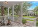 Inviting front porch framed by white columns, offering neighborhood views at 212 Greenwich Dr., Conway, SC 29526