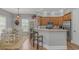An eat-in kitchen features stainless steel appliances and wood cabinets with bar stool seating at 212 Greenwich Dr., Conway, SC 29526