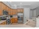 A kitchen features stainless steel appliances, wood cabinets and light countertops at 212 Greenwich Dr., Conway, SC 29526
