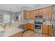 A kitchen features stainless steel appliances, wood cabinets, and light countertops at 212 Greenwich Dr., Conway, SC 29526