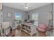Office with wood-look floors, ceiling fan, two windows and desk with decor at 212 Greenwich Dr., Conway, SC 29526