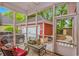 Screened porch features outdoor seating and a view of a detached garage and patio at 212 Greenwich Dr., Conway, SC 29526