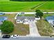 Spacious property featuring a well-maintained lawn, storage building, and charming single story home at 212 Sweetbay Magnolia St., Loris, SC 29569