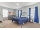 Bedroom with blue accent pieces features a bed, sofa, and multiple large windows allowing for natural light at 212 Sweetbay Magnolia St., Loris, SC 29569