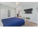 Bright bedroom features blue accent pieces, closet, and TV at 212 Sweetbay Magnolia St., Loris, SC 29569