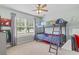 Bedroom features a bunk bed with a ceiling fan and a large window letting in natural light at 212 Sweetbay Magnolia St., Loris, SC 29569
