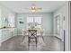 Bright dining area with a modern table set, complemented by ample natural light and a serene ambiance at 212 Sweetbay Magnolia St., Loris, SC 29569