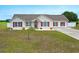Charming single-story home with red shutters and a well-maintained lawn at 212 Sweetbay Magnolia St., Loris, SC 29569
