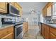 Open kitchen featuring granite counters, stainless steel appliances, and an easy view to the adjacent living room at 212 Sweetbay Magnolia St., Loris, SC 29569