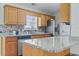 Well-appointed kitchen with stainless steel appliances, granite countertops, and mosaic backsplash, ideal for culinary enthusiasts at 212 Sweetbay Magnolia St., Loris, SC 29569
