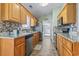 Efficient kitchen layout featuring granite countertops, stainless steel appliances, and a convenient tile backsplash at 212 Sweetbay Magnolia St., Loris, SC 29569