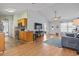 Cozy living room featuring hardwood floors, vaulted ceilings and seamlessly connecting to an adjacent eat-in kitchen at 212 Sweetbay Magnolia St., Loris, SC 29569