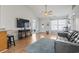 Bright living room featuring hardwood floors, ceiling fan, and an open view to the foyer at 212 Sweetbay Magnolia St., Loris, SC 29569