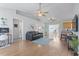 Spacious living room with hardwood floors, ceiling fans, and a seamless open floor plan at 212 Sweetbay Magnolia St., Loris, SC 29569