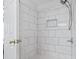 This tiled shower features a shower head with a handheld sprayer and a soap dish at 212 Sweetbay Magnolia St., Loris, SC 29569