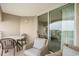 Relaxing balcony with sliding glass door, table, and comfortable wicker chairs with a view at 2151 Bridge Ct. # 1-305, North Myrtle Beach, SC 29582