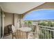Comfortable covered balcony with outdoor seating and neighborhood views on a sunny day at 2151 Bridge Ct. # 1-305, North Myrtle Beach, SC 29582