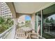 Inviting covered balcony with a wooden table and chairs, offering a glimpse of the neighborhood at 2151 Bridge Ct. # 1-305, North Myrtle Beach, SC 29582